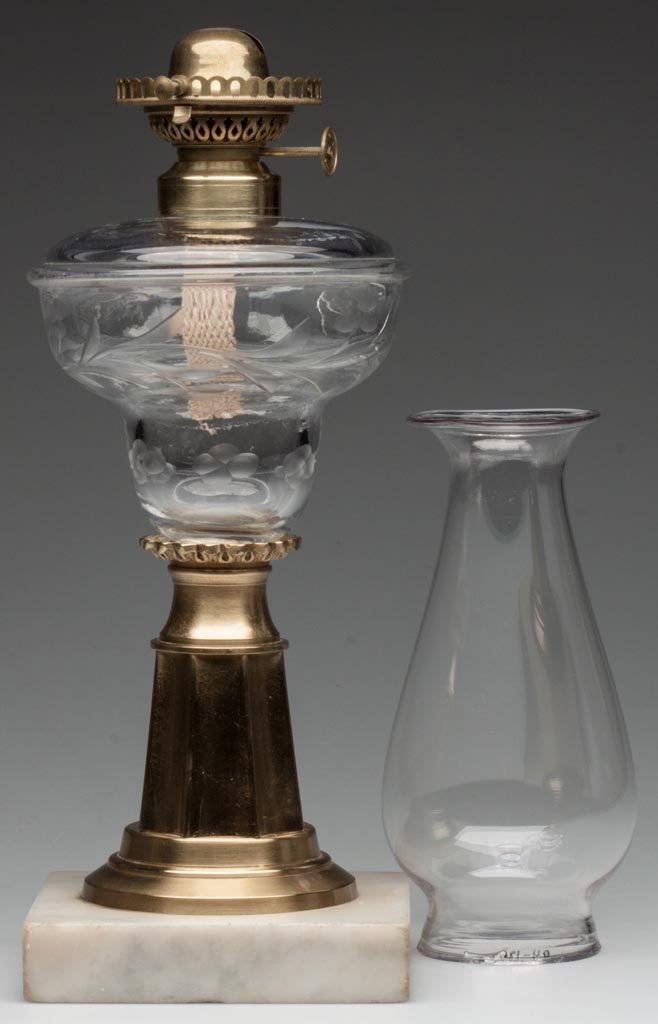 MOLDED AND CUT "DODGE"-TYPE FONT STAND LAMP: MOLDED AND CUT "DODGE"-TYPE FONT STAND LAMP colorless with cut vine and floral pattern, font peg is encased with a threaded cast-brass "rosette"-type sleeve, brass paneled stem, marble base, No. 1 fin