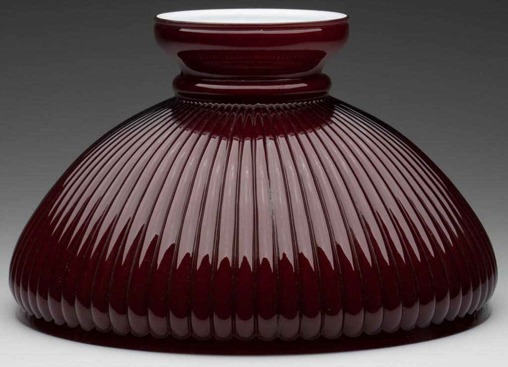 NARROW STRAIGHT RIBBED SHADE: NARROW STRAIGHT RIBBED SHADE, cased maroon, umbrella form. Late 19th/early 20th century. 7 1/2" H, 12" D fitter. Literature: Parallels Miller/Solverson - Student Lamps of the Victorian Era, p. 89, fig