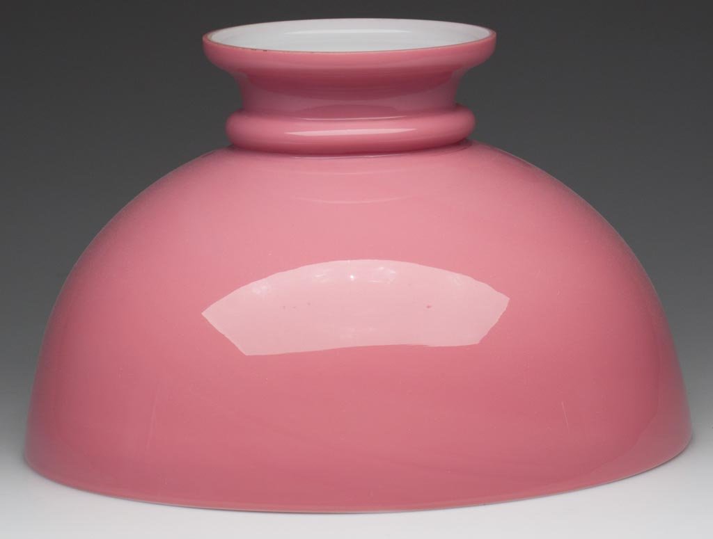 UNPATTERNED CROWNED DOME-FORM SHADE: UNPATTERNED CROWNED DOME-FORM SHADE, cased pink, factory-polished top rim. Fourth quarter 19th century. 8" H, 11 3/4" D fitter. Provenance: From the collection of the late Dorothy J. Gooch.