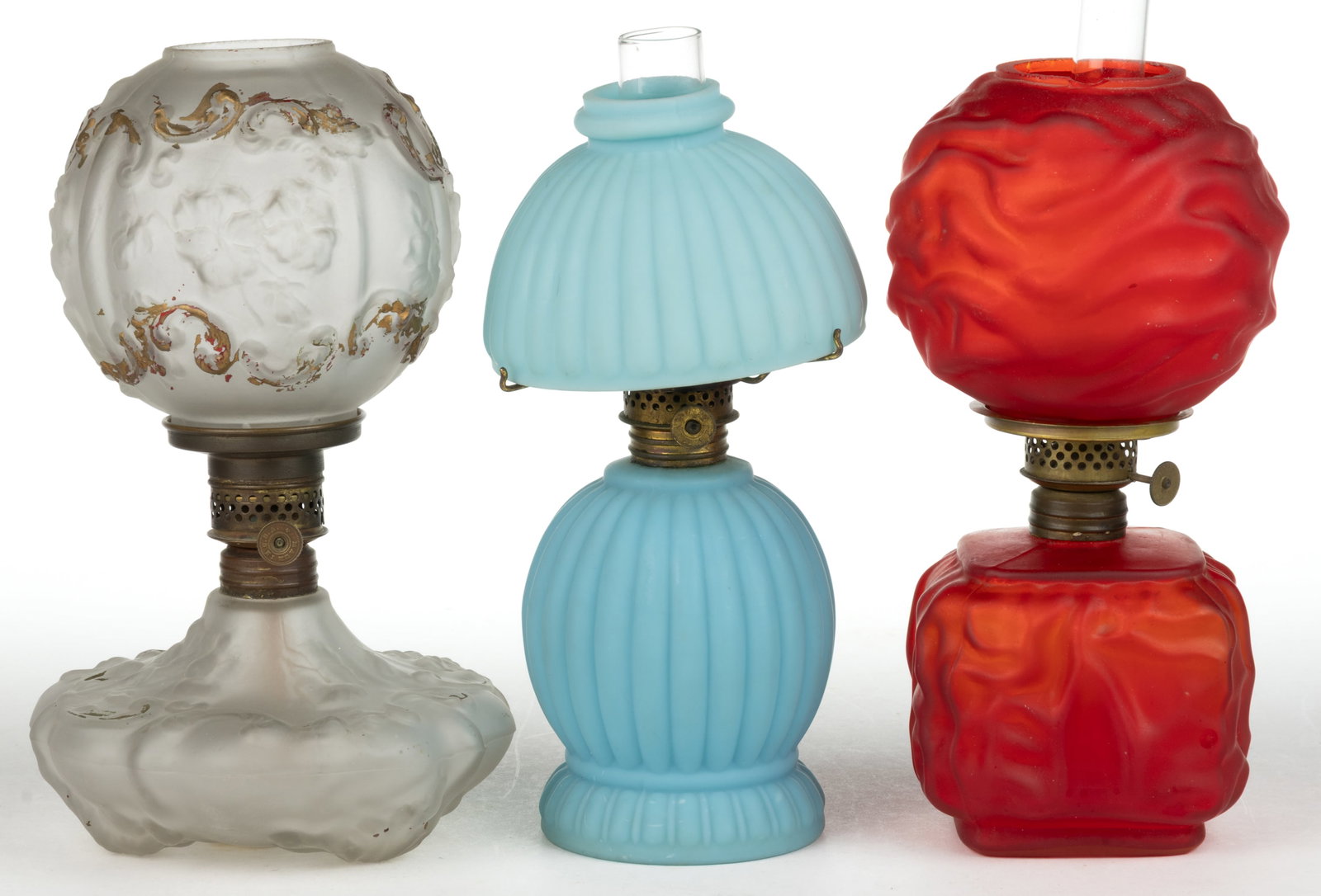 ASSORTED SATIN GLASS MINIATURE LAMPS, LOT OF THREE: ASSORTED SATIN GLASS MINIATURE LAMPS, LOT OF THREE, each with matching patterned shade, comprising a cased ruby/cranberry Drape/Smith II, fig 231; a colorless with enamel decoration Spiderweb/Pansy/Sm