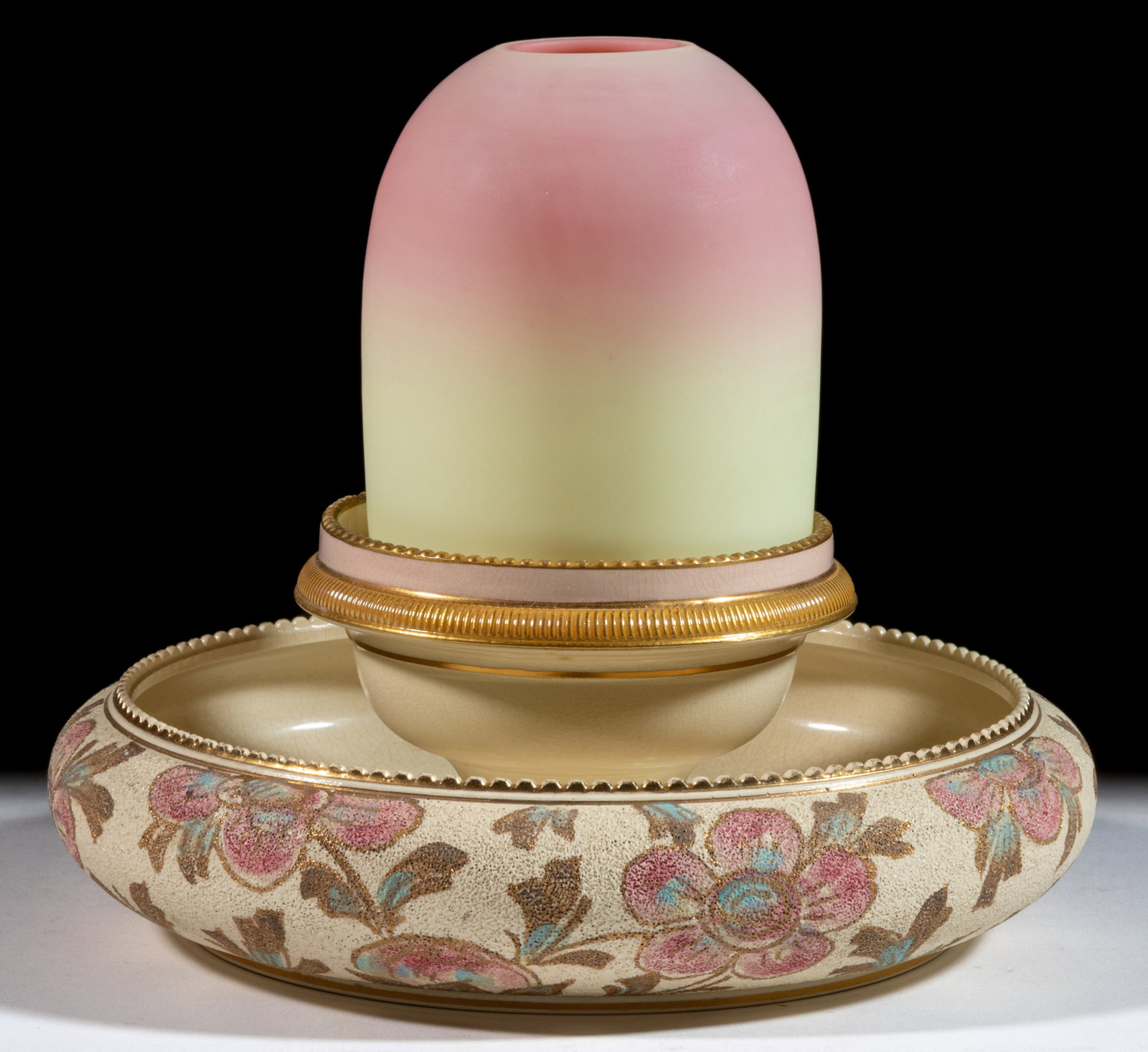 THOMAS WEBB BURMESE GLASS AND ENGLISH TAPESTRY-WARE CERAMIC FAIRY LAMP: THOMAS WEBB BURMESE GLASS AND ENGLISH TAPESTRY-WARE CERAMIC FAIRY LAMP, plush finish fairy-size dome, two-part construction comprising the dome fitted on a circular-form ceramic bowl with folded-