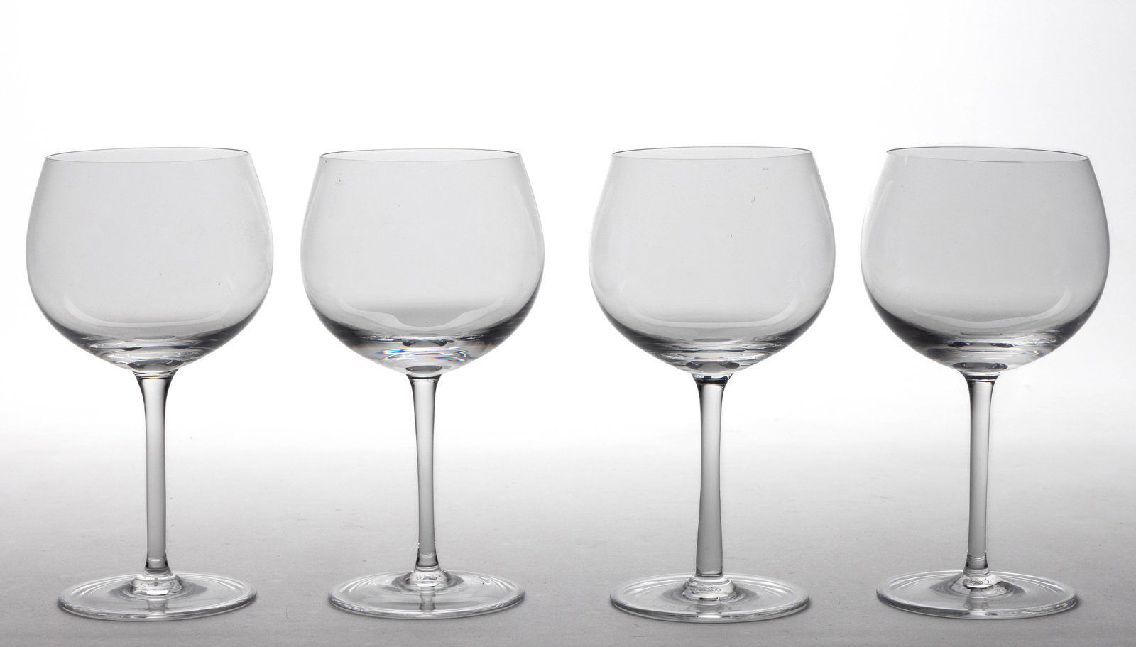 TIFFANY CRYSTAL WHITE WINE GLASSES, LOT OF FOUR: TIFFANY CRYSTAL WHITE WINE GLASSES, LOT OF FOUR, colorless, each signed to the underside. Tiffany & Co. 20th century. 7 1/8" H.