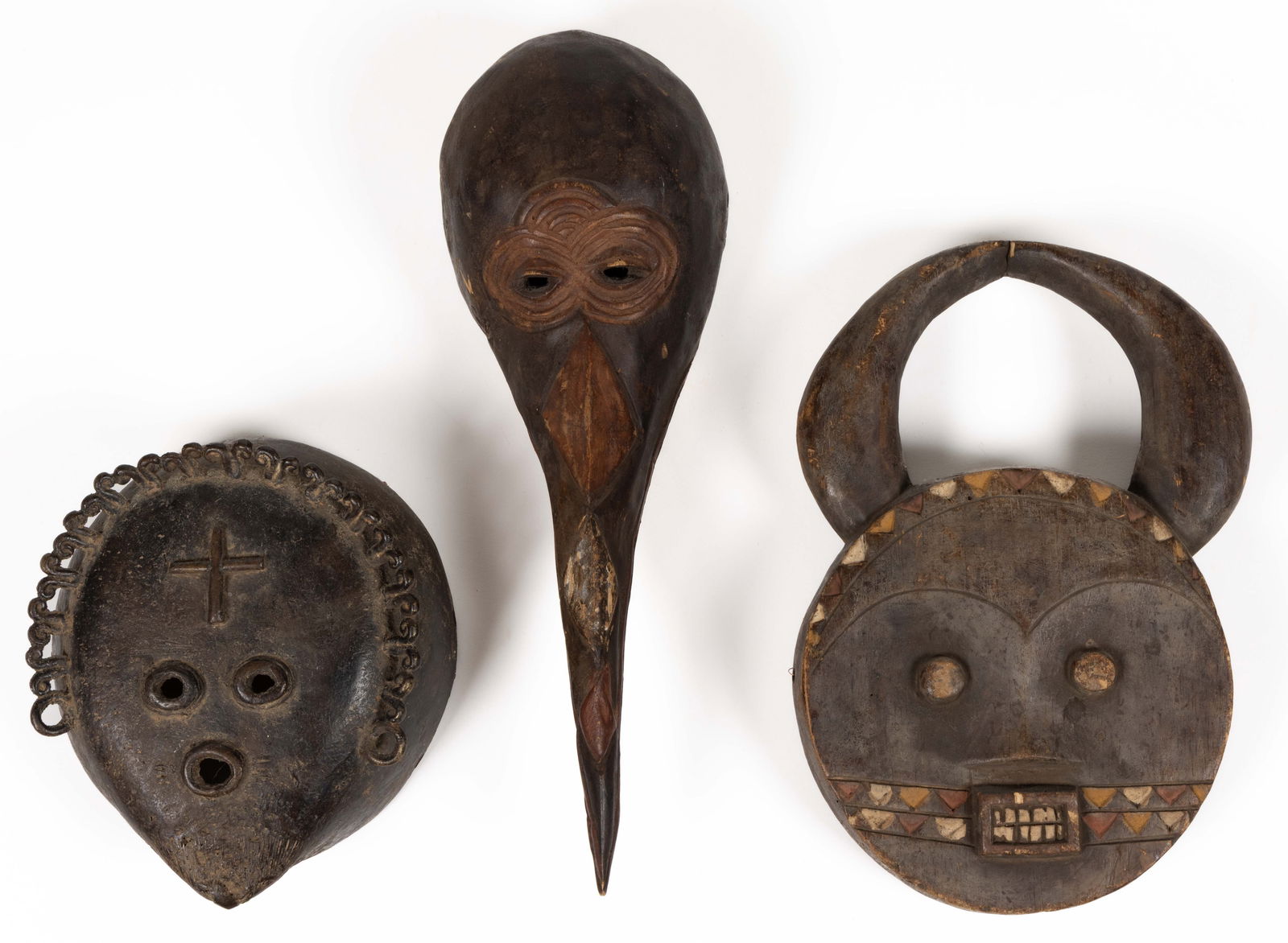AFRICAN CARVED AND PAINTED WOODEN AND IRON TRIBAL MASKS, LOT OF THREE (1 of 2)