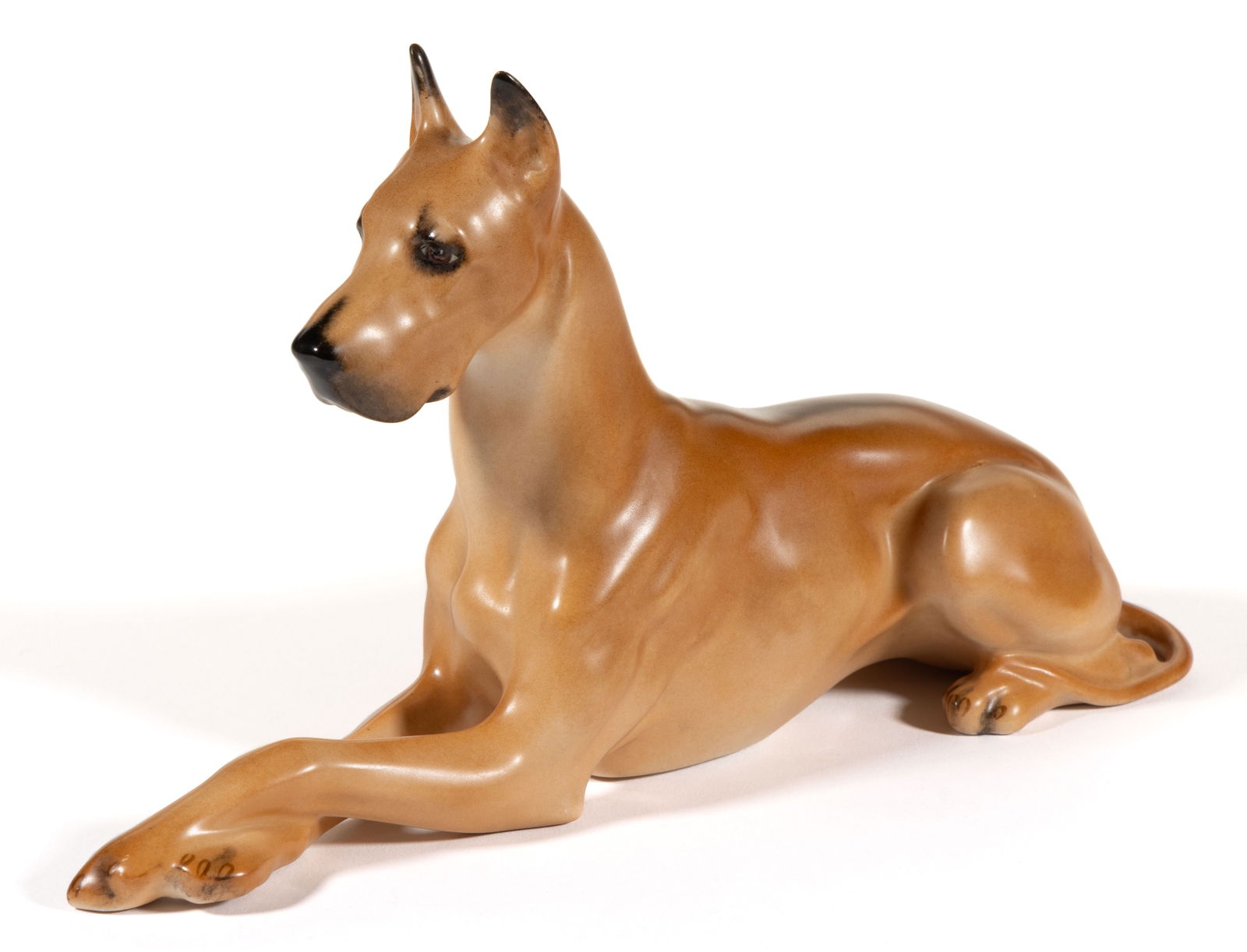 AMERICAN BOEHM PORCELAIN DOG FIGURE: AMERICAN BOEHM PORCELAIN DOG FIGURE, featuring a polychrome hand-painted recumbent Great Dane with front paws crossed. Brown-printed "T Boehm" to stomach. Edward Marshall Boehm (1912-1969) P