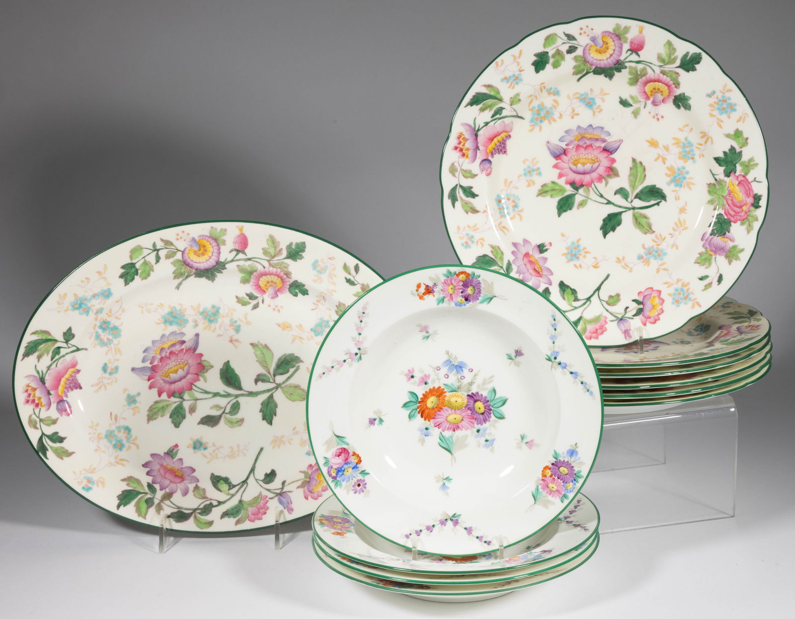 ENGLISH WEDGWOOD FLORAL MOTIF CERAMIC TABLE ARTICLES, LOT OF 11: ENGLISH WEDGWOOD FLORAL MOTIF CERAMIC TABLE ARTICLES, LOT OF 11, comprising six dinner plates with shaped rims and an oval platter, all with green-banded rims, polychrome printed and hand-painted