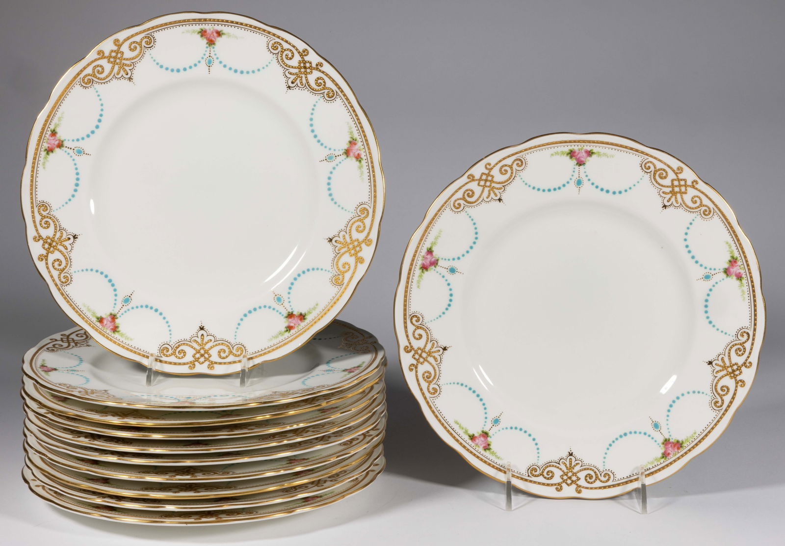 ENGLISH GEORGE JONES & SONS FOR TIFFANY & CO. CERAMIC SERVICE PLATES, LOT OF 11: ENGLISH GEORGE JONES & SONS FOR TIFFANY & CO. CERAMIC SERVICE PLATES, LOT OF 11, pattern #14223, featuring border with dotted gilt scrolled designs and three transfer roses with turq