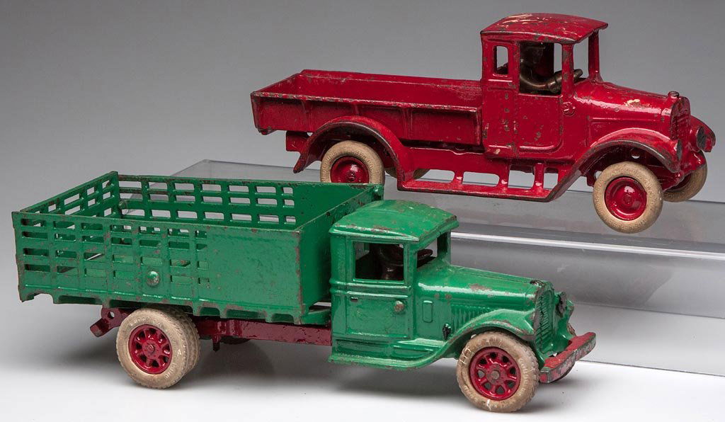ARCADE CAST-IRON TOY TRUCKS, LOT OF TWO: ARCADE CAST-IRON TOY TRUCKS, LOT OF TWO, each with rubber tires and nickel driver, old repaint. First quarter 20th century. 10" and 12" L. Provenance: From the Rudolph Evers estate collection, Bridgew