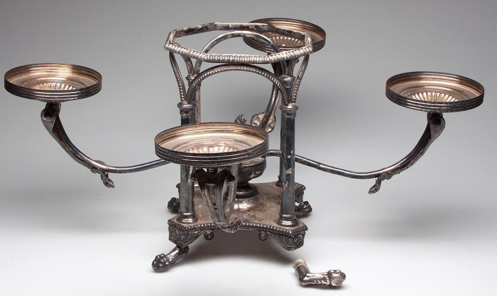 NEO-CLASSICAL STYLE SILVER-PLATE EPERGNE STAND: NEO-CLASSICAL STYLE SILVER-PLATE EPERGNE STAND, four arms emanating from the center, raised on four claw feet. 20th century. 11 1/2" H. Provenance: From the Rudolph Evers estate collection, Bridgewate