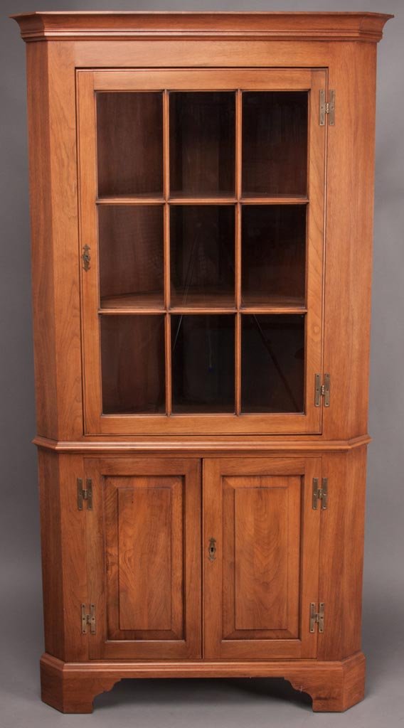 HENKEL-HARRIS VIRGINIA GALLERIES WALNUT CORNER CUPBOARD: HENKEL-HARRIS VIRGINIA GALLERIES WALNUT CORNER CUPBOARD, cove-molded cornice above a single nine-pane door and two lower doors. Winchester, VA. Fourth quarter 20th century. 75" H, 36" W. Provenance: F