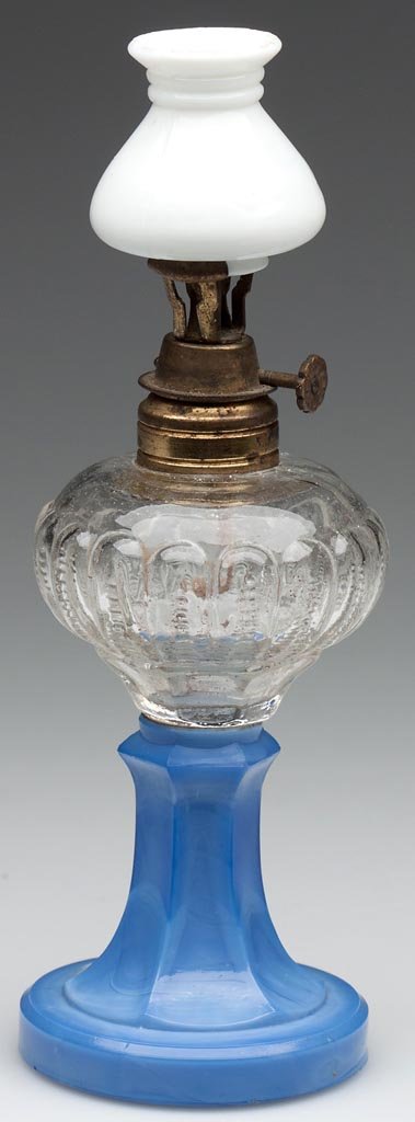 SMITH I, FIG. 11 (RIGHT) / LOOPED ZIPPER MINIATURE STAN: SMITH I, FIG. 11 (RIGHT) / LOOPED ZIPPER MINIATURE STAND LAMP, colorless blown-molded font, opaque starch-blue base with slightly swirling light opal, collar with patent information, opaque white chim