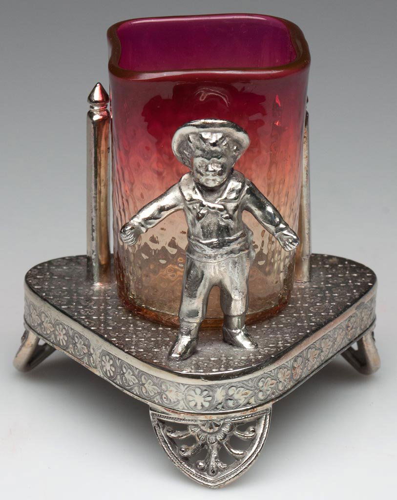 VENETIAN DIAMOND-OPTIC SQUARE-TOP TOOTHPICK HOLDER: VENETIAN DIAMOND-OPTIC SQUARE-TOP TOOTHPICK HOLDER, amberina with fuchsia at rim, polished pontil mark, fitted in a silver-plated stand with Kate Greenaway figure, marked for James Tufts and numbered