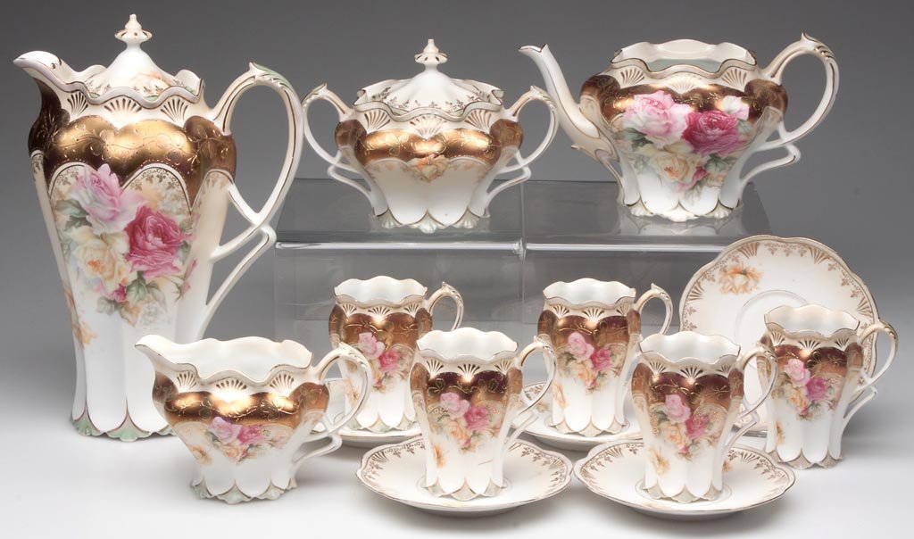 R. S. PRUSSIA FLORAL-DECORATED BEVERAGE ARTICLES, LOT O: R. S. PRUSSIA FLORAL-DECORATED BEVERAGE ARTICLES, LOT OF 14, comprising a chocolate pot with five cups and saucers, and a three-piece tea set, pot lacking cover, all mold 501 with matching transfer-pr