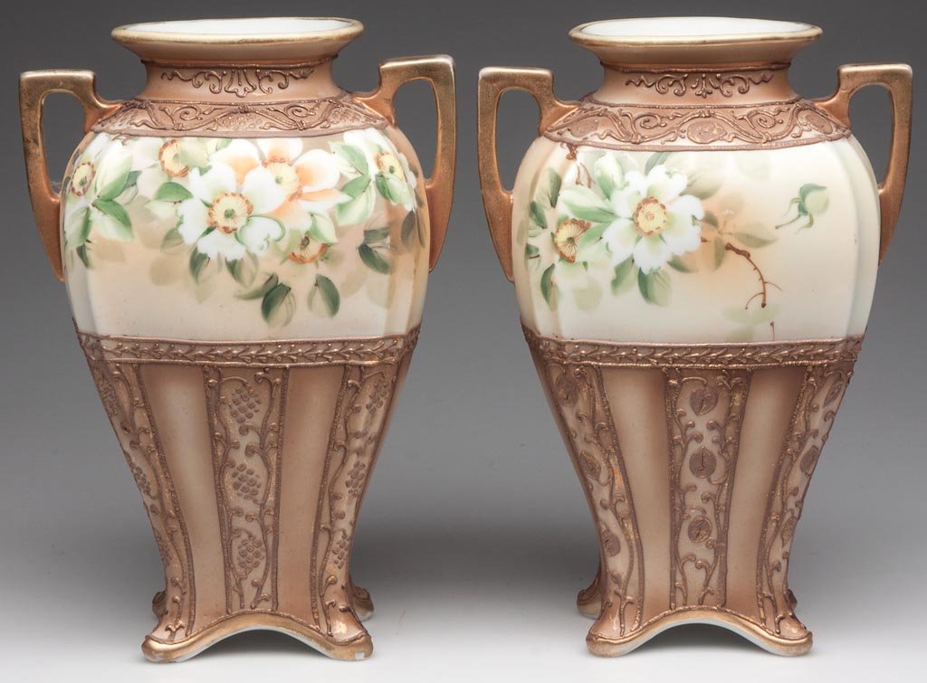 NIPPON FLORAL VASES, PAIR: NIPPON FLORAL VASES, PAIR, two-handle square baluster form with two open handles at shoulder and flared feet, raised moriage centering a band of painted white dogwood flowers, green M-in-wreath marks.