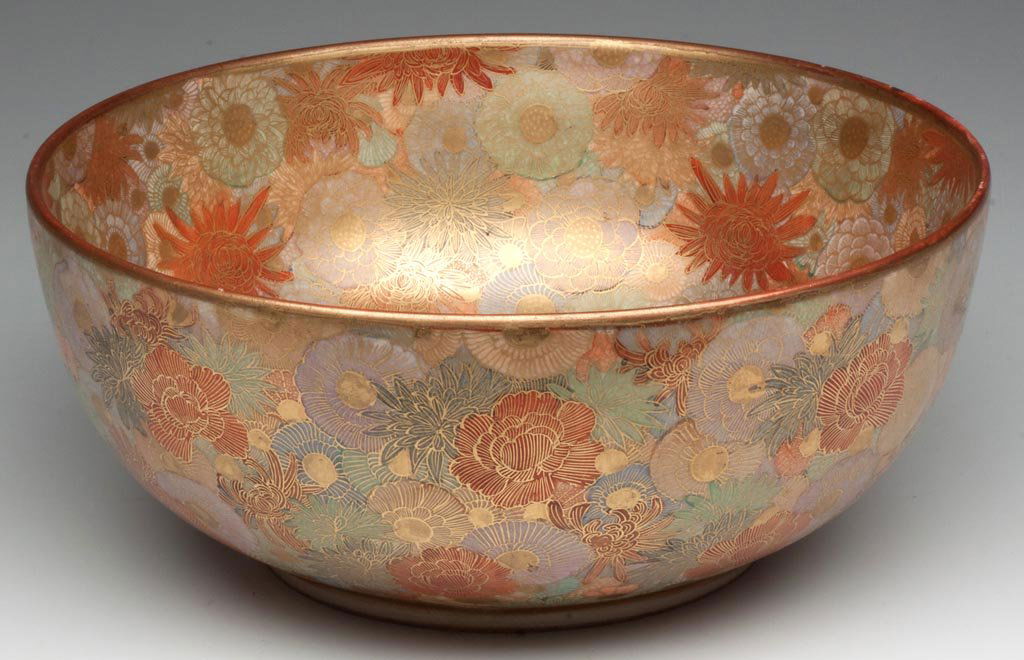 JAPANESE KUTANI SATSUMA EARTHENWARE BOWL: JAPANESE KUTANI SATSUMA EARTHENWARE BOWL, all-over intricate floral and gilt decoration, gilt signature on a red rectangular panel to underside. Late 19th/early 20th century. 3 1/2" H, 8 1/2" D. Prove