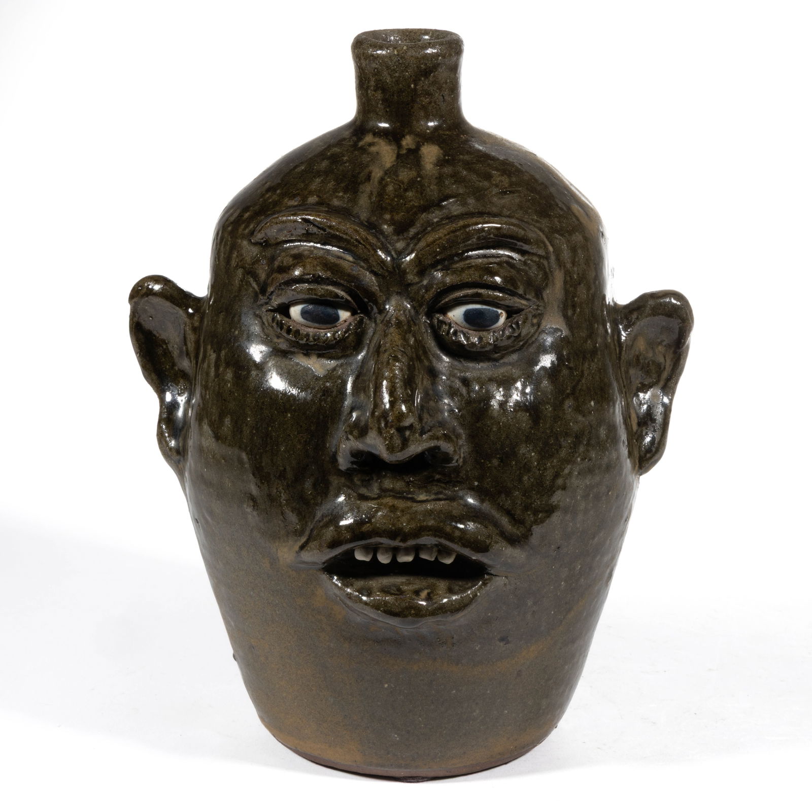 SIGNED "LANIER MEADERS" (AMERICAN, 1917-1998), GEORGIA STONEWARE FACE JUG: SIGNED "LANIER MEADERS" (AMERICAN, 1917-1998), GEORGIA STONEWARE FACE JUG, runny alkaline glaze, hand-modeled having inset ceramic eyes with black pupils, applied eyebrows and protrudin