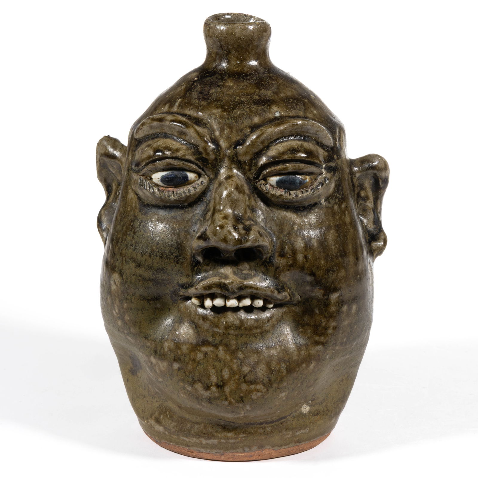 SIGNED "LANIER MEADERS" (AMERICAN, 1917-1998), GEORGIA STONEWARE FACE JUG: SIGNED "LANIER MEADERS" (AMERICAN, 1917-1998), GEORGIA STONEWARE FACE JUG, runny alkaline glaze, hand-modeled with inset ceramic eyes with black pupils, applied eyebrows and protruding ears,