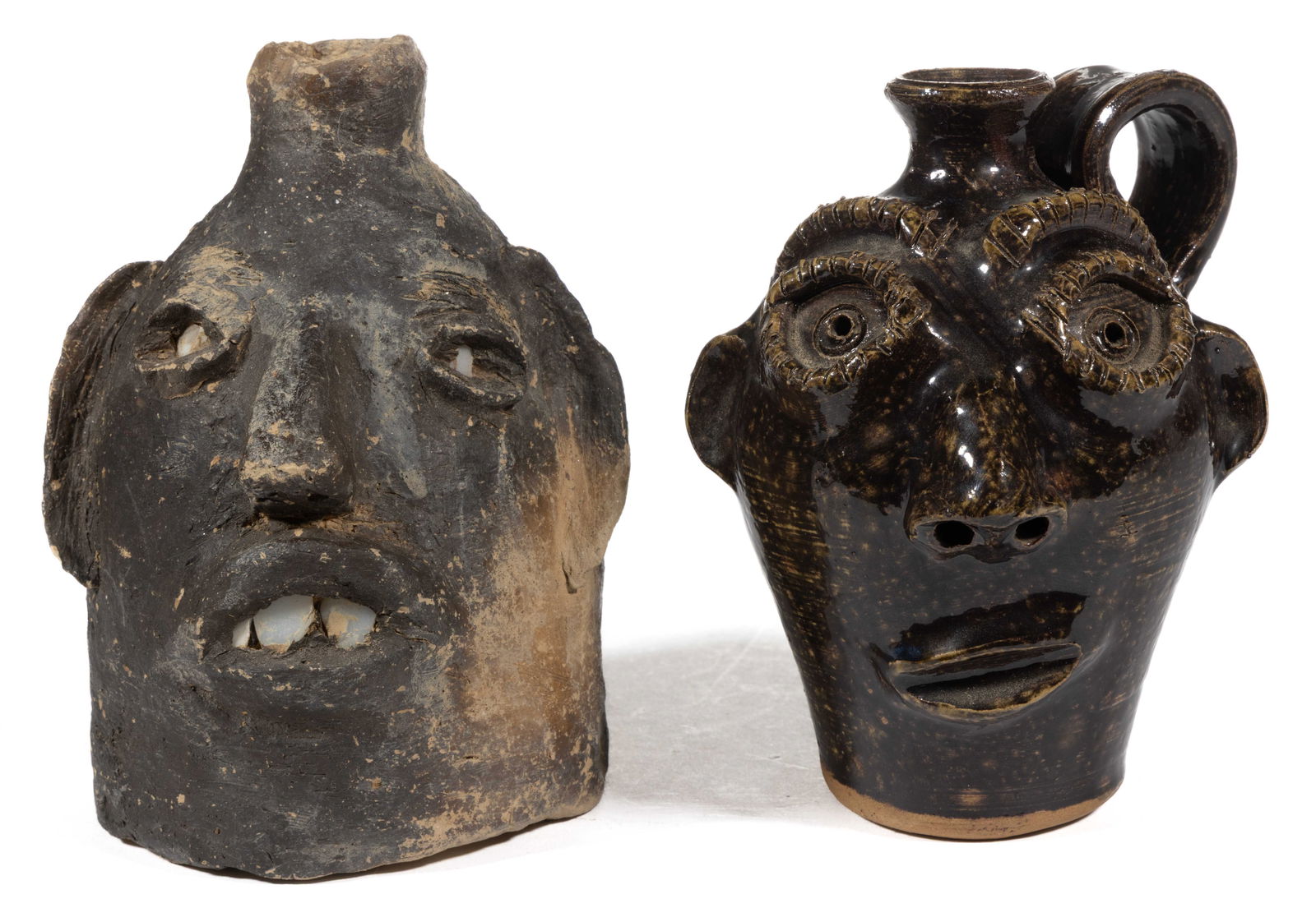 SIGNED GEORGIA EARTHENWARE / STONEWARE FACE JUGS, LOT OF TWO: SIGNED GEORGIA EARTHENWARE / STONEWARE FACE JUGS, LOT OF TWO, each having applied features including eyelids, ears, nose, and lips, comprising one "Stanley / Ferguson" Alkaline-glazed e