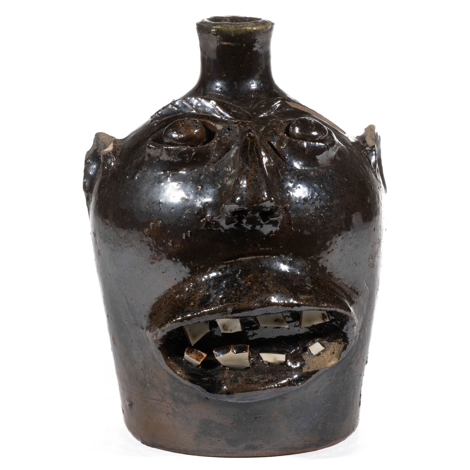 POSSIBLE BROWN BROTHERS, ARDEN, NORTH CAROLINA STONEWARE FACE JUG: POSSIBLE BROWN BROTHERS, ARDEN, NORTH CAROLINA STONEWARE FACE JUG, hand-modeled expressive form having applied eyebrows, beady clay eyes, nose with pierced nostrils, and open mouth with eight white ce