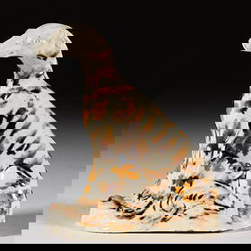 ENGLISH STAFFORDSHIRE CREAMWARE WHIELDON-TYPE CERAMIC DOG FIGURE: ENGLISH STAFFORDSHIRE CREAMWARE WHIELDON-TYPE CERAMIC DOG FIGURE, featuring a greyhound-like canine sitting on a molded ovoid base with tail tucked under back leg and ears laid back with bro