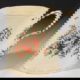 ENGLISH CREAMWARE HAND-PAINTED PERSONALIZED CERAMIC TANKARD: ENGLISH CREAMWARE HAND-PAINTED PERSONALIZED CERAMIC TANKARD, cylindrical form with applied double-intertwined handles, molded flower and foliate terminals, and beaded ring below rim and abov