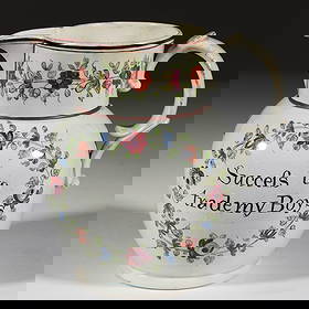 BRITISH PEARLWARE HAND-PAINTED FLORAL MOTIF CERAMIC JUG: BRITISH PEARLWARE HAND-PAINTED FLORAL MOTIF CERAMIC JUG, globular form, having polychrome designs including a floral bouquet to one side, reverse featuring a wreath with "Succefs to / trade