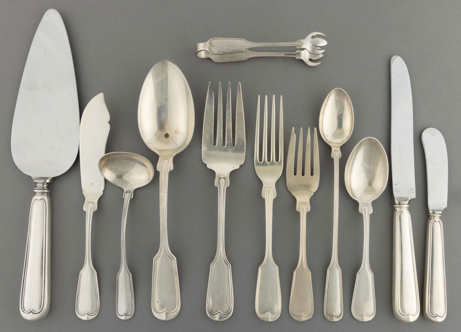 FRANK W. SMITH "FIDDLE THREAD" STERLING SILVER 86-PIECE FLATWARE SERVICE: FRANK W. SMITH "FIDDLE THREAD" STERLING SILVER 86-PIECE FLATWARE SERVICE, pattern designed in 1902; solid sterling pieces comprising 16 7" L place forks, 16 salad forks, 12 5 3/4"L