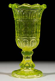 PRESSED GOTHIC ARCH, PRINTIE PANEL, AND LOOP CELERY VASE: PRESSED GOTHIC ARCH, PRINTIE PANEL, AND LOOP CELERY VASE, canary yellow/Vaseline (reacts under black light), flared nine-scallop rim, hexagonal paneled stem, and circular foot, wafer construction. New