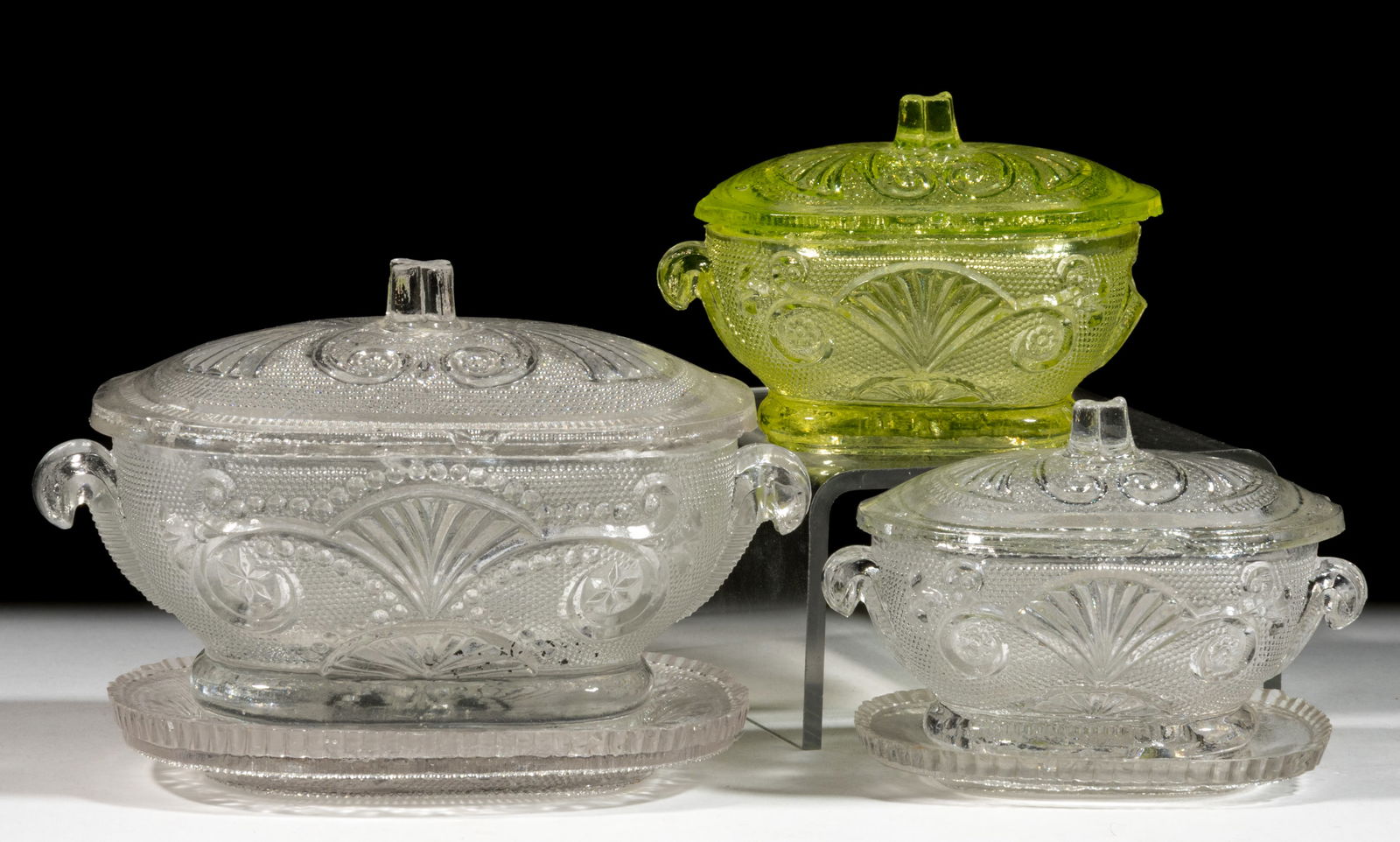 PRESSED LACY LARGE AND SMALL TOY COVERED TUREENS, LOT OF THREE: PRESSED LACY LARGE AND SMALL TOY COVERED TUREENS, LOT OF THREE, colorless and canary yellow (reacts under black light), various fan, lily, scroll, star, and diamond design elements, tureen with molded