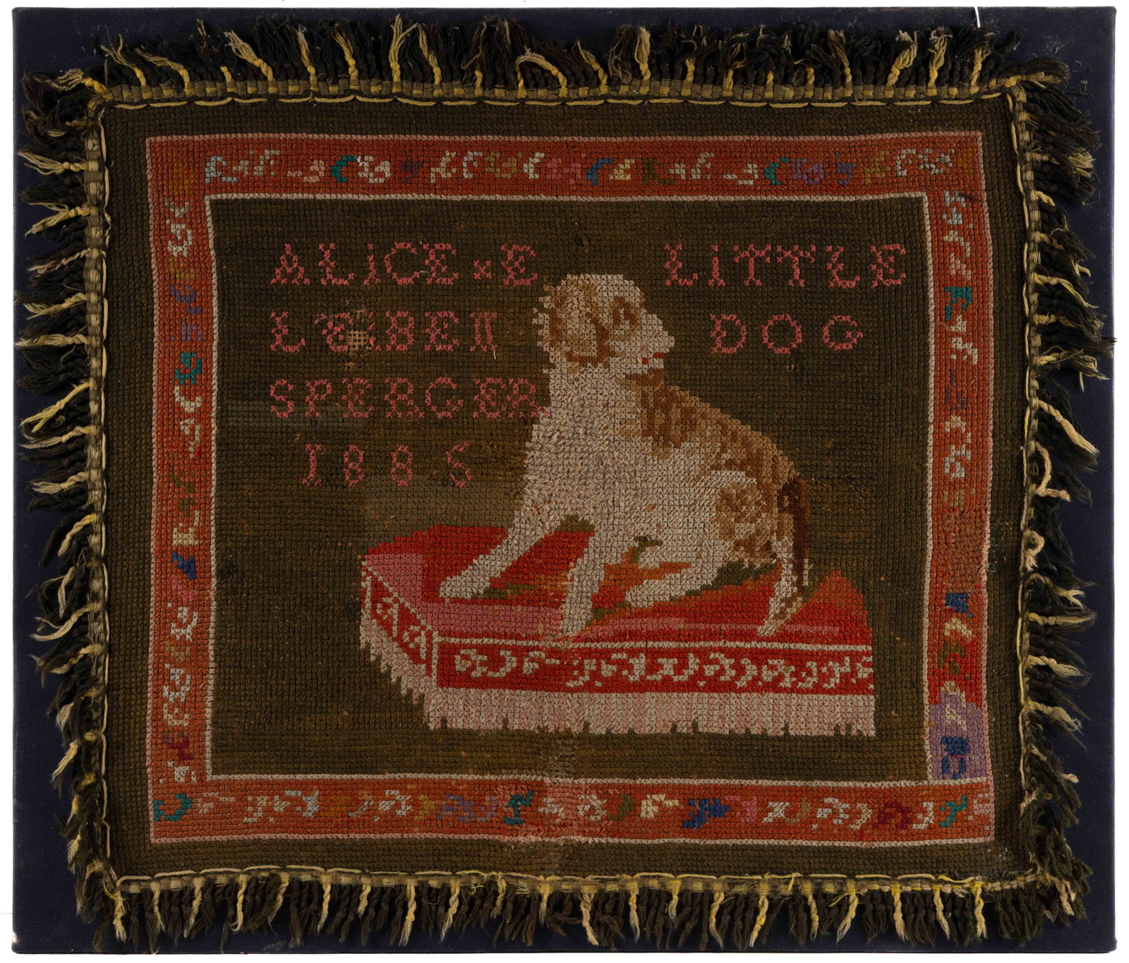 AMERICAN FOLK ART DATED 1885 AND DOG PICTORIAL HOOKED RUG: AMERICAN FOLK ART DATED 1885 AND DOG PICTORIAL WOVEN RUG, rectangular form, depicting a small-breed brown and white canine sitting on a red pillow and having facial features, pink