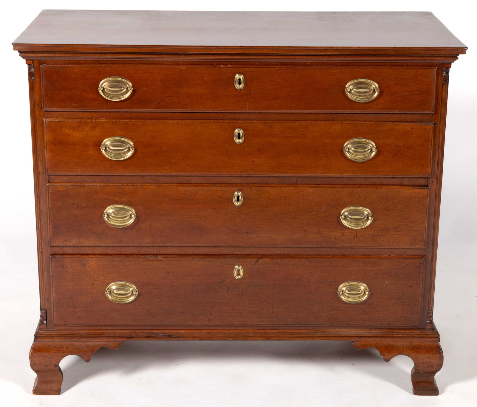 PENNSYLVANIA CHIPPENDALE CHERRY CHEST OF DRAWERS: PENNSYLVANIA CHIPPENDALE CHERRY CHEST OF DRAWERS, the rectangular top with a molded edge and applied molding beneath over four graduated full drawers flanked by fluted corner columns and solid ends, t