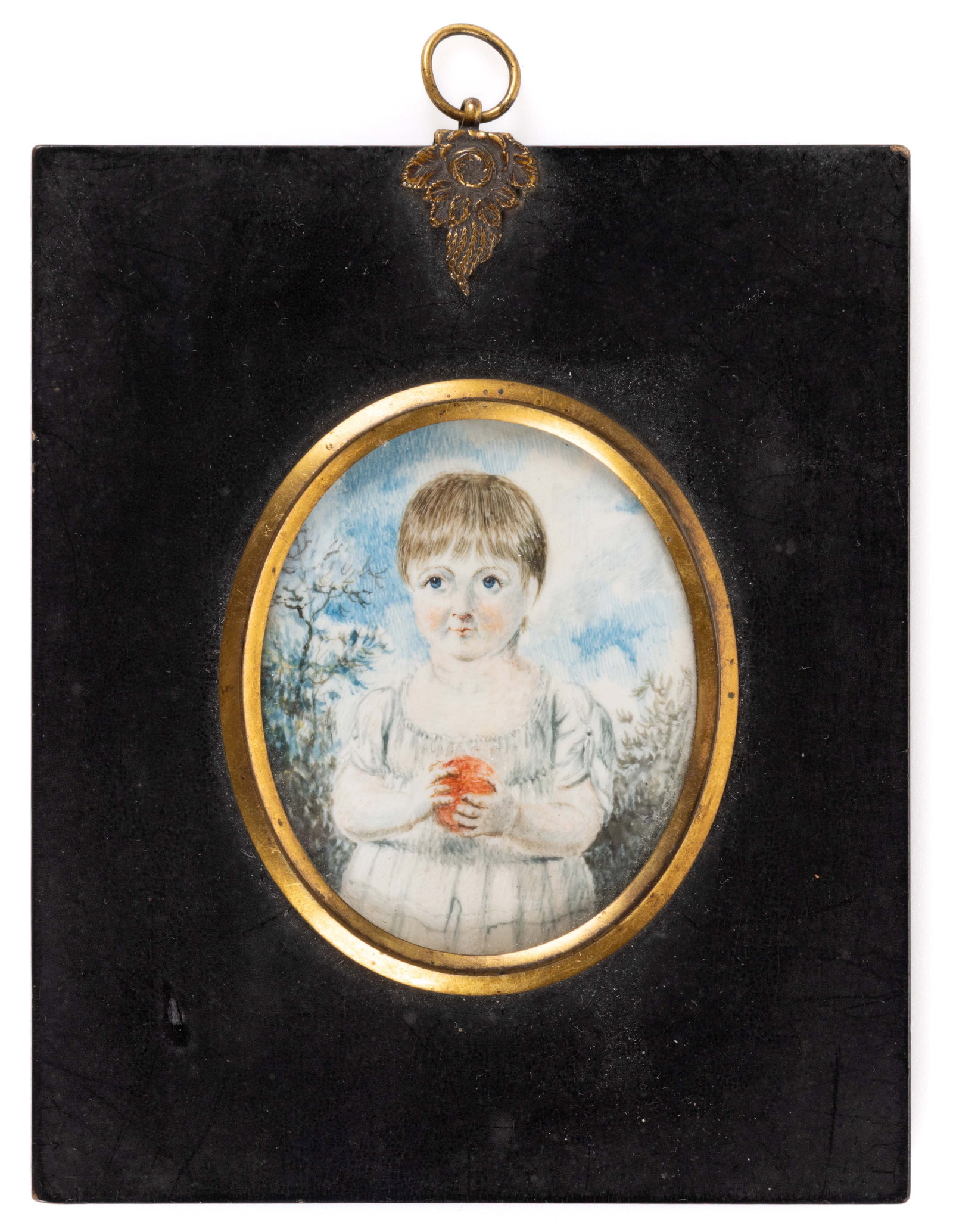 AMERICAN SCHOOL (19TH CENTURY) MINIATURE PORTRAIT OF A GIRL: AMERICAN SCHOOL (19TH CENTURY) MINIATURE PORTRAIT OF A GIRL, watercolor, depicting a young girl with bright blue eyes holding an apple (or ball) outdoors with trees behind her. No signature located. H
