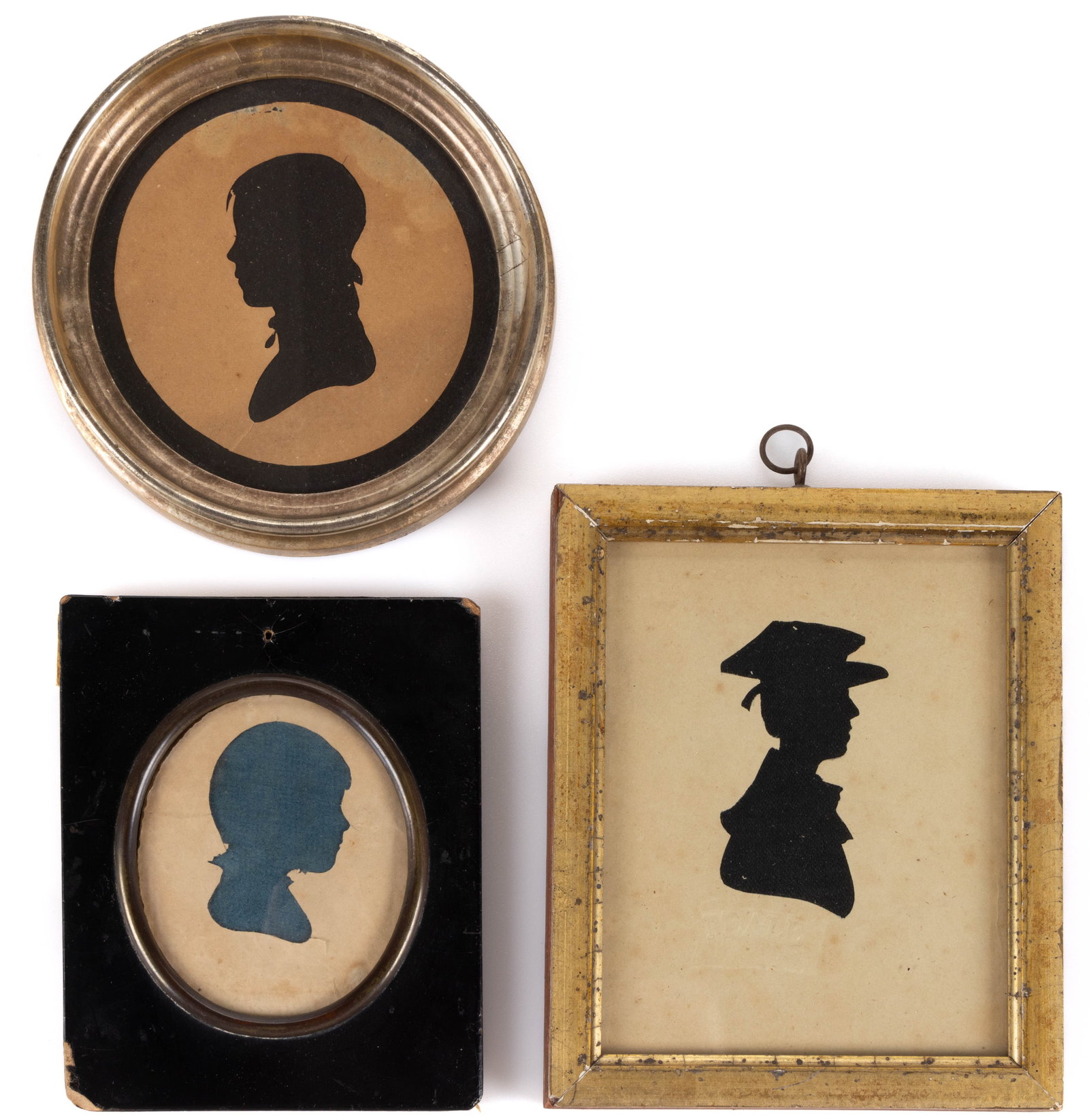 AMERICAN / BRITISH SCHOOL (19TH CENTURY) HOLLOW-CUT SILHOUETTES, LOT OF THREE: AMERICAN / BRITISH SCHOOL (19TH CENTURY) HOLLOW-CUT SILHOUETTES, LOT OF THREE, each being a bust depiction of a child or boy, one stamped for the Peale Museum. Each is housed under glass in a per