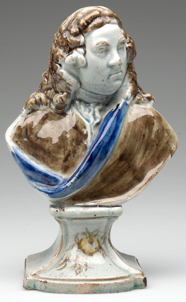 ENGLISH STAFFORDSHIRE PEARLWARE BUST OF HANDEL BY RALPH: ENGLISH STAFFORDSHIRE PEARLWARE BUST OF HANDEL BY RALPH WOOD,, facing left with characteristic curled long hair and cape; on a quatrefoil flaring stepped rectangular plinth, decorated with colored gla