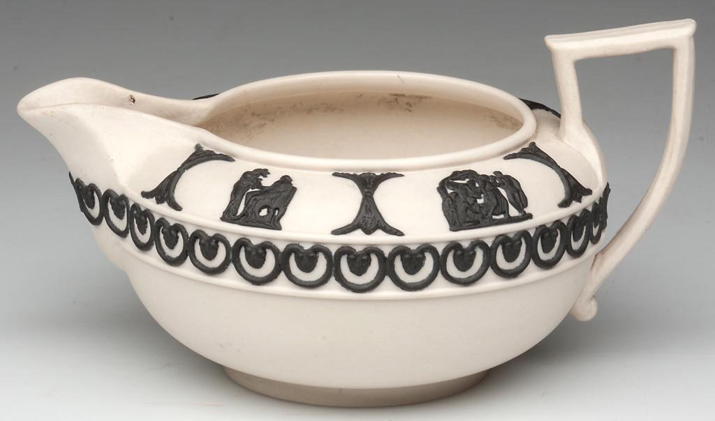 SARREGUEMINES NEO-CLASSICAL CANEWARE LOW CREAMER: SARREGUEMINES NEO-CLASSICAL CANEWARE LOW CREAMER, integral spout and flat-topped strap handle, the cream-colored body with a tube-band applied to the rim, and additional tubes to the high waist, the s