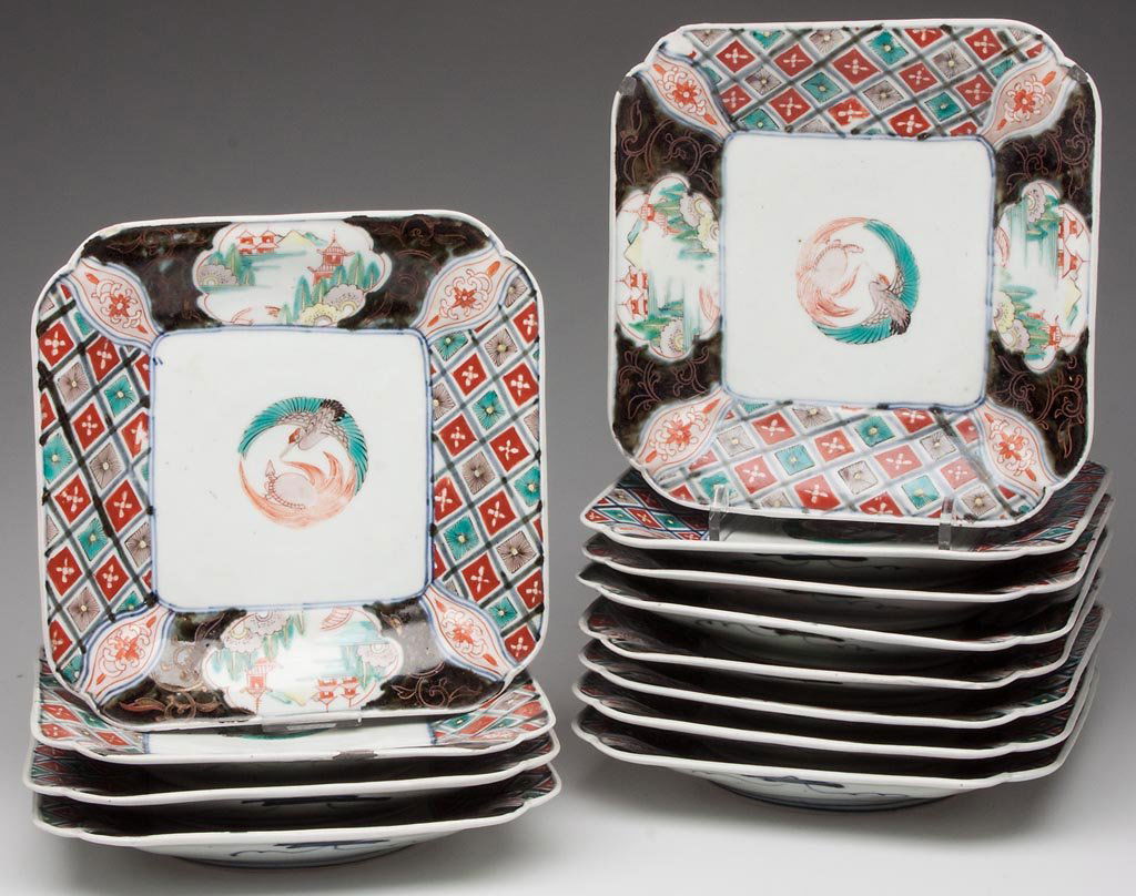 ASIAN IMARI PORCELAIN SET OF 12 CANTED-CORNERED DISHES: ASIAN IMARI PORCELAIN SET OF 12 CANTED-CORNERED DISHES, all with steep-angled sides, centering the "penciled" figures of a green and black crane and iron-red dragon forming a circle; with cobalt-blue