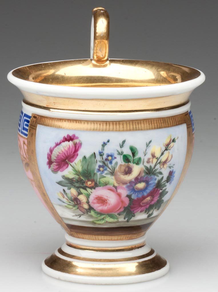 "OLD PARIS" PORCELAIN CABINET CUP ON PEDESTAL FOOT: "OLD PARIS" PORCELAIN CABINET CUP ON PEDESTAL FOOT, the pink-ground cup with an high-arching handle with a lotus-leaf spread within its ring, terminating at the bottom with a serrated palm leaf molded