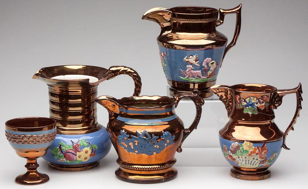 ENGLISH STAFFORDSHIRE COPPER-LUSTER EARTHENWARE LOT OF : ENGLISH STAFFORDSHIRE COPPER-LUSTER EARTHENWARE LOT OF FOUR PITCHERS AND A GOBLET, the largest pitcher with a bold, everted neck, serpent-form handle and elongated ring-molded neck over a squat, globu