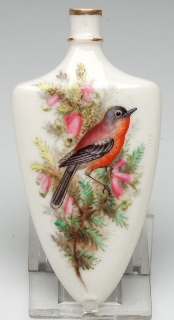 ROYAL WORCESTER PORCELAIN SCENT BOTTLE: ROYAL WORCESTER PORCELAIN SCENT BOTTLE, in the form of a shield, painted with birds in branches of lupin and spruce, the verso with a sparrow among heather, unmarked. Circa 1880. 3 5/8" H. Provenance: