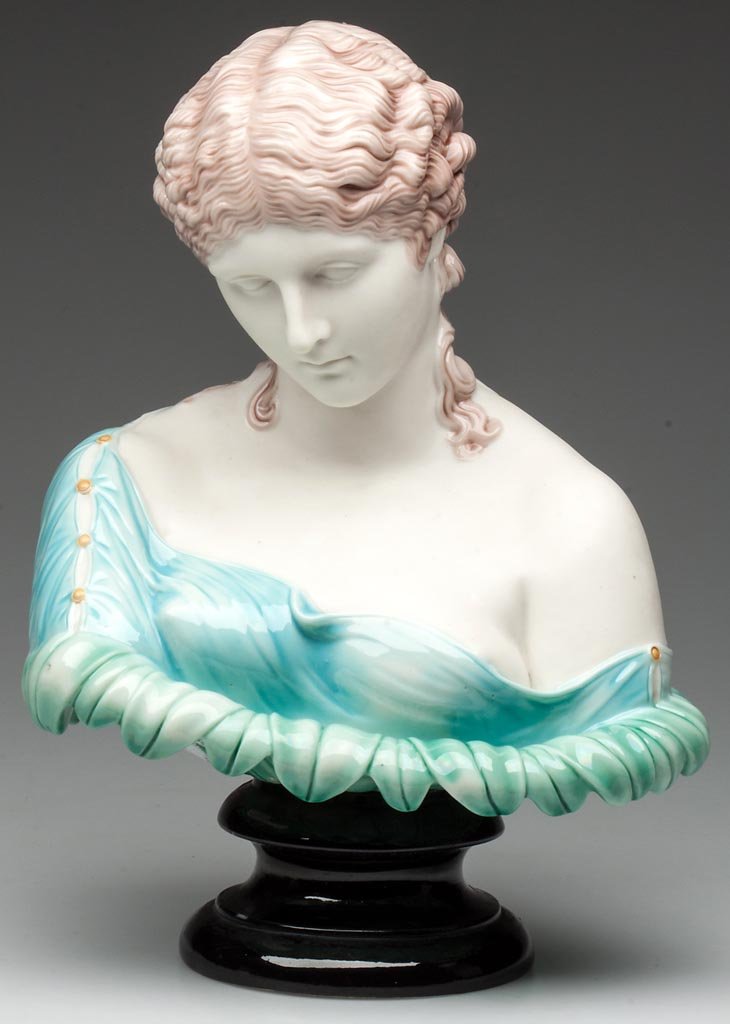ROYAL WORCESTER PARIAN PORCELAIN VICTORIAN FIGURAL BUST: ROYAL WORCESTER PARIAN PORCELAIN VICTORIAN FIGURAL BUST OF "CLYTIE", on a socle base, the robed bust of a woman emergent from a many-petalled flower, the dress and petals glazed and enameled in pale a