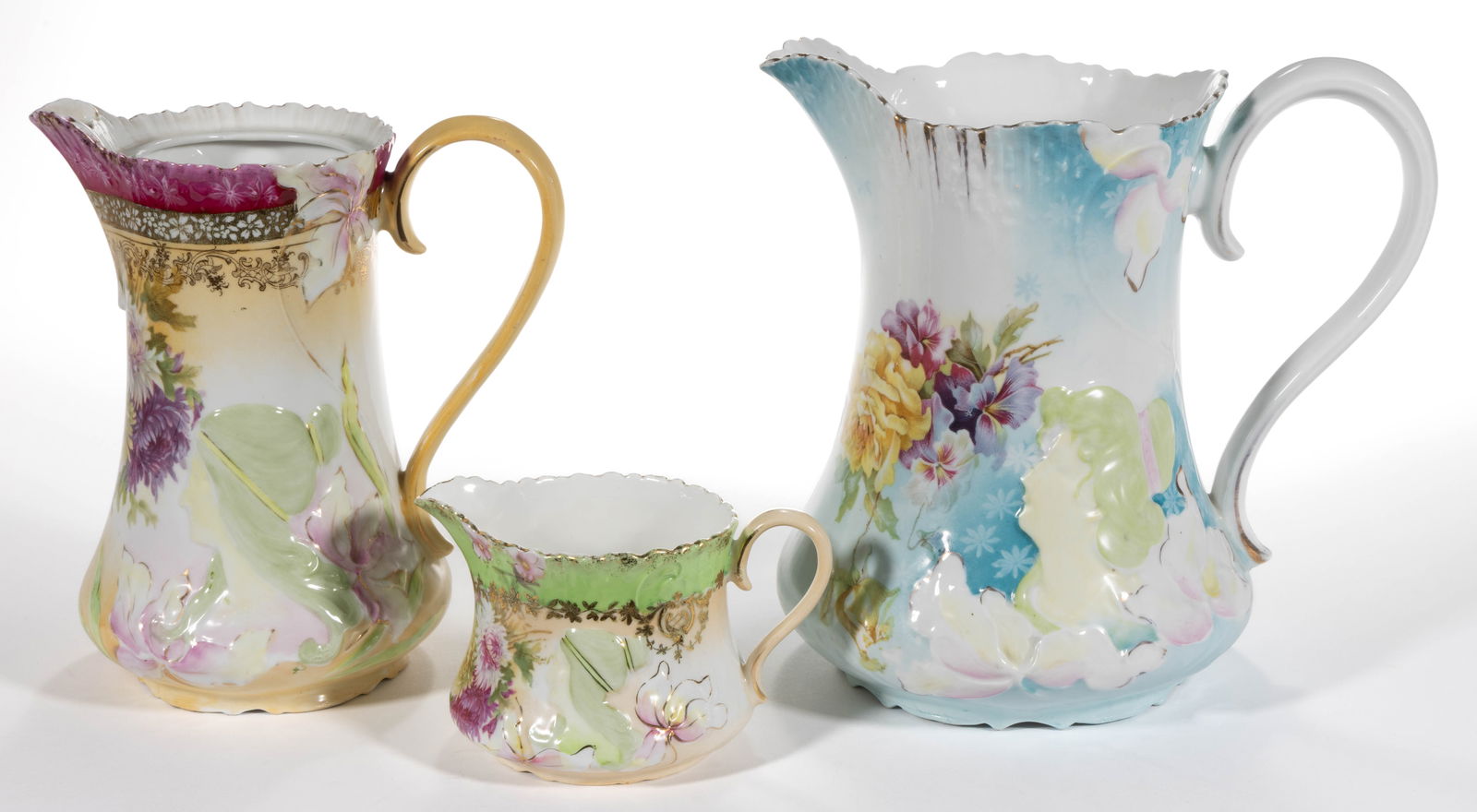 R.S. PRUSSIA PORCELAIN HIDDEN IMAGE PITCHERS, LOT OF THREE: R.S. PRUSSIA PORCELAIN HIDDEN IMAGE PITCHERS, LOT OF THREE, each having embossed image of a woman with hair in a bun and flowers, comprising a water pitcher having decor HI 5, a creamer and a cho