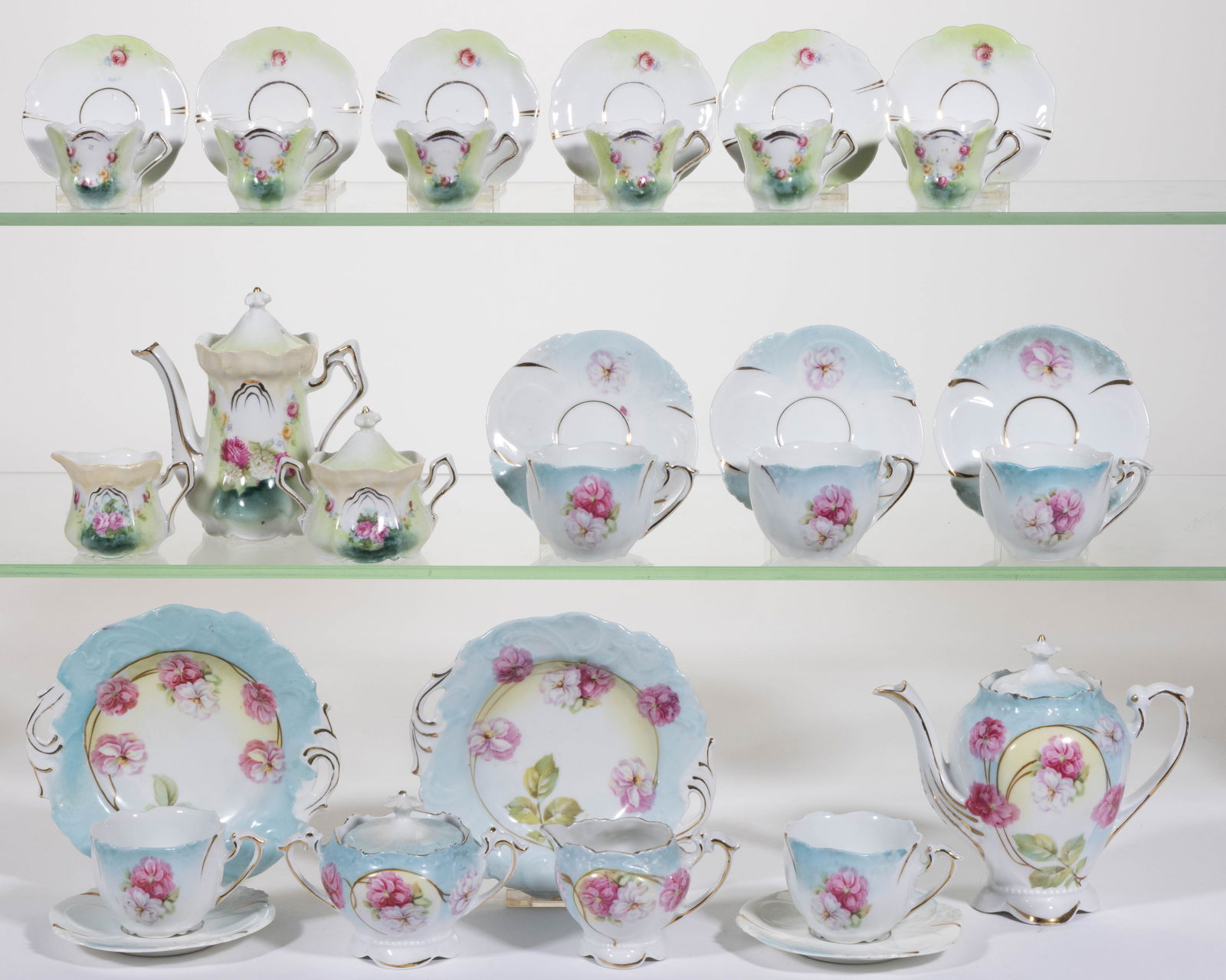 R.S. PRUSSIA PORCELAIN FLORAL MOTIF CHILDREN'S TEA SETS, LOT OF TWO: R.S. PRUSSIA PORCELAIN FLORAL MOTIF CHILDREN'S TEA SETS, LOT OF TWO, each consisting of fifteen pieces, comprising one set featuring charming pink flowers emanating from a curved stem with&nb