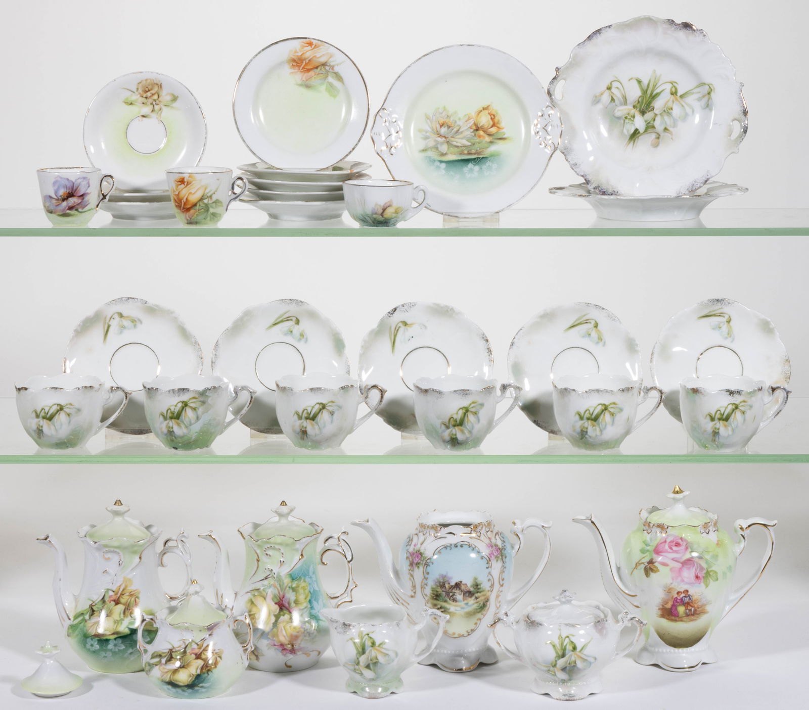 R.S. PRUSSIA PORCELAIN CHILDREN'S TEA ARTICLES, LOT OF 33: R.S. PRUSSIA PORCELAIN CHILDREN'S TEA ARTICLES, LOT OF 33, including a teapot and a covered sugar featuring drooping yellow rose motif, a teapot having yellow rose with delicate white flowers