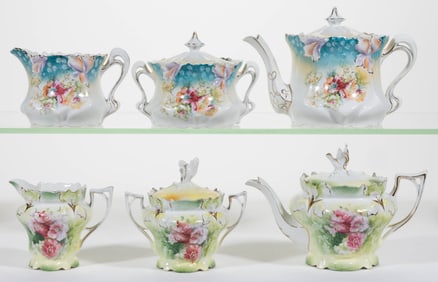R.S. PRUSSIA PORCELAIN FLORAL MOTIF THREE-PIECE TEA SETS, LOT OF TWO