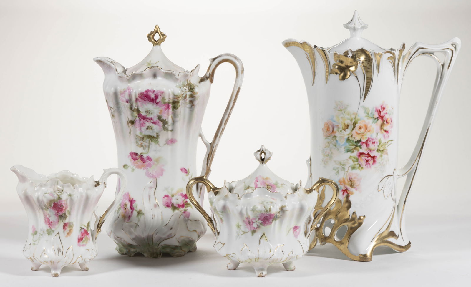 R.S. PRUSSIA PORCELAIN FLORAL MOTIF CHOCOLATE ARTICLES, LOT OF FOUR: R.S. PRUSSIA PORCELAIN FLORAL MOTIF CHOCOLATE ARTICLES, LOT OF FOUR, comprising a RS Steeple Mold 14 chocolate pot and a three-piece RSP Mold 703 set with matching pattern comprising a