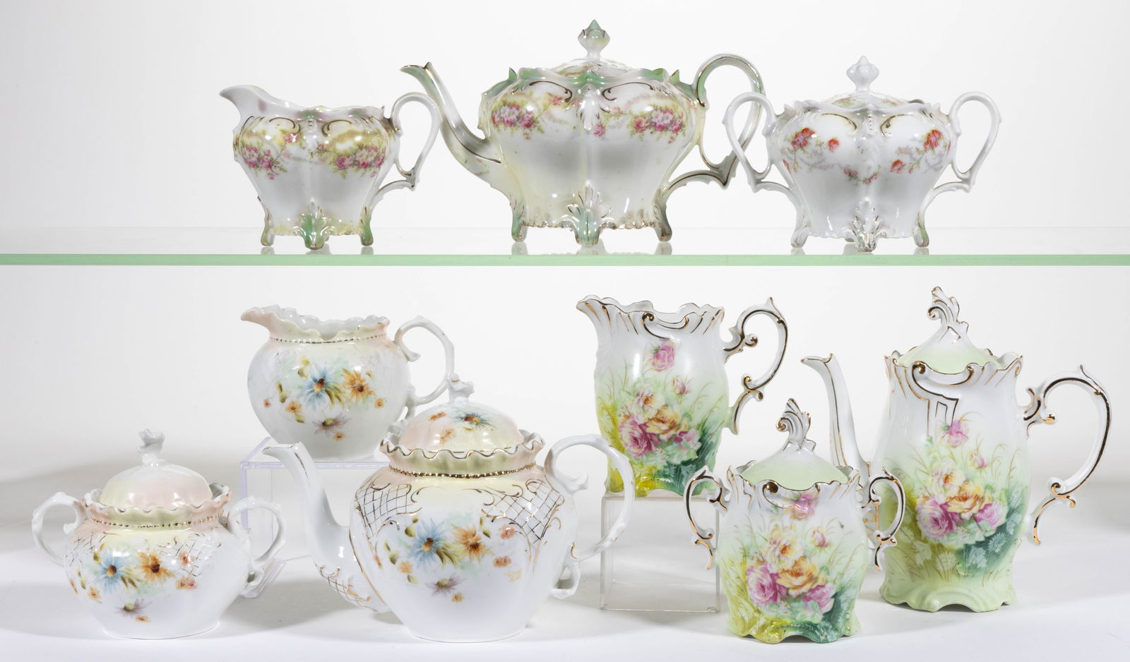 R.S. GERMANY / PRUSSIA PORCELAIN FLORAL MOTIF THREE-PIECE TEA SETS, LOT OF THREE: R.S. GERMANY / PRUSSIA PORCELAIN FLORAL MOTIF THREE-PIECE TEA SETS, LOT OF THREE, each consisting of a teapot, a covered sugar, and a creamer, comprising a Mold OM 7 set with ruffled rims and