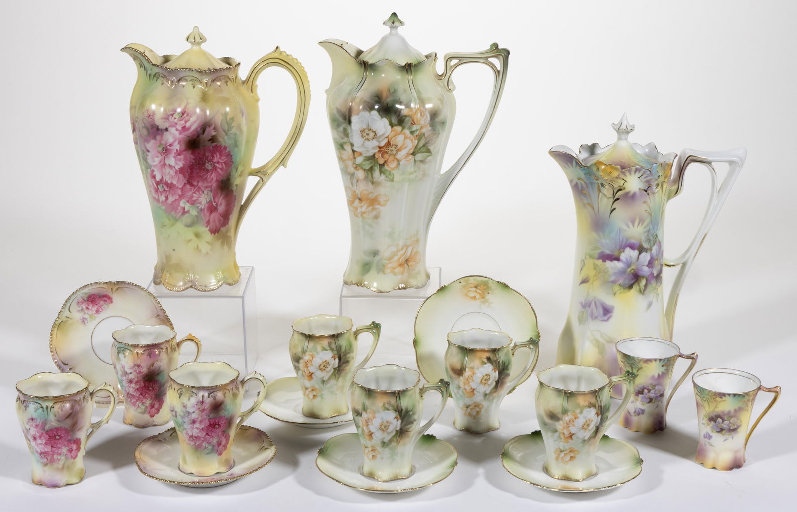 R.S. PRUSSIA PORCELAIN FLORAL MOTIF CHOCOLATE ARTICLES, LOT OF 18: R.S. PRUSSIA PORCELAIN FLORAL MOTIF CHOCOLATE ARTICLES, LOT OF 18, each having yellow ground, comprising a RSP Mold 29 pot and two cups with purple clematis transfer decoration, a RSP Mold 507 pot and