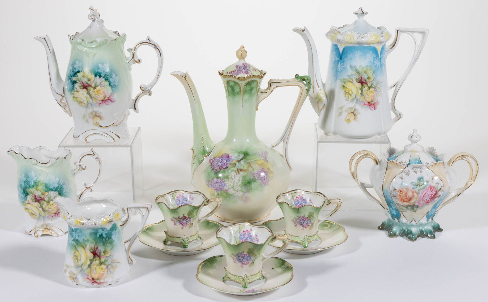 R.S. PRUSSIA PORCELAIN FLORAL MOTIF DEMITASSE AND OTHER RELATED ARTICLES, LOT OF NINE: R.S. PRUSSIA PORCELAIN FLORAL MOTIF DEMITASSE AND OTHER RELATED ARTICLES, LOT OF NINE, comprising a RSP Mold 474 low-bodied demitasse pot and three cup and saucer sets featuring lilac transfers,