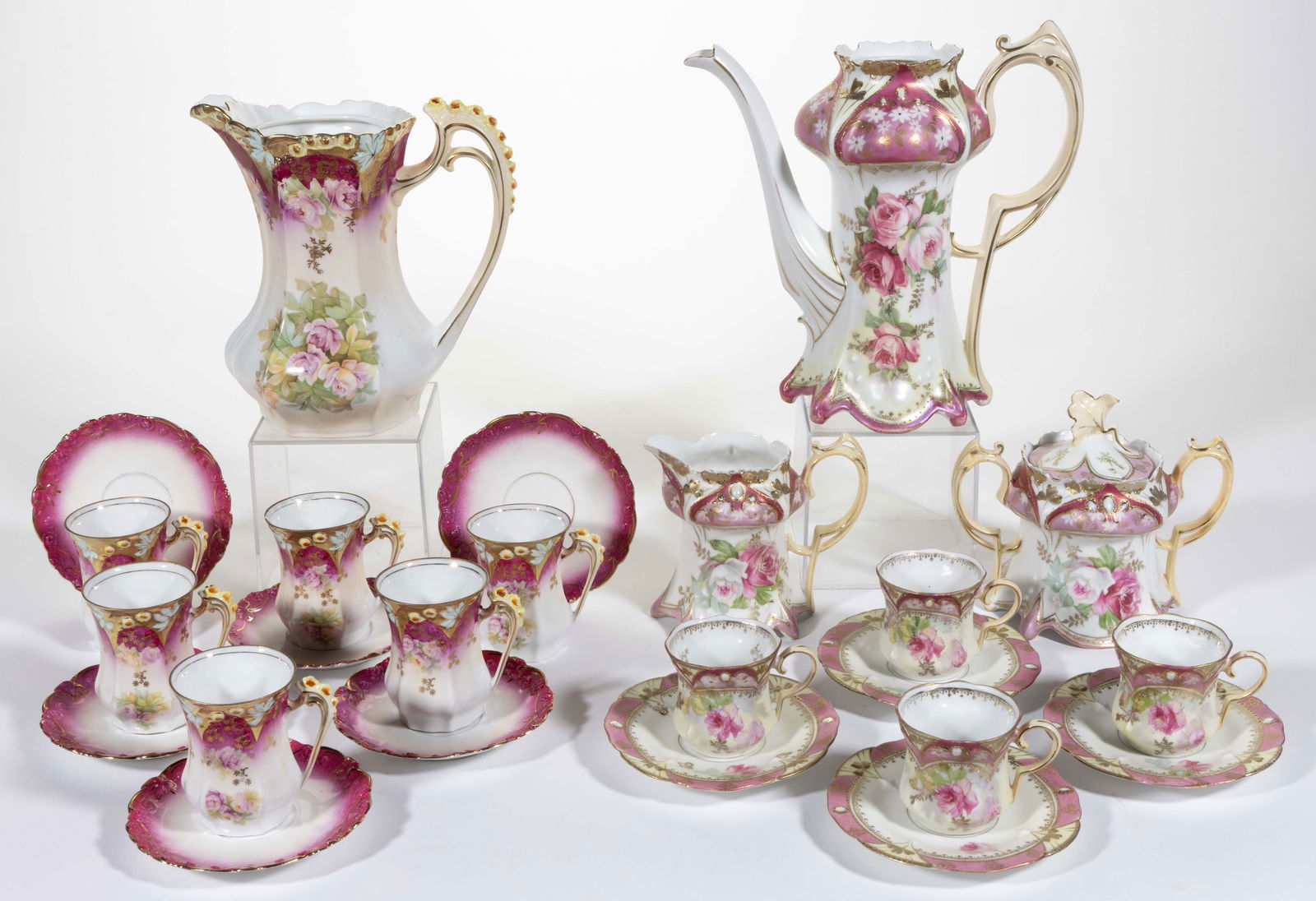 R.S. GERMANY / PRUSSIA PORCELAIN FLORAL MOTIF CHOCOLATE AND COFFEE ARTICLES, LOT OF 14: R.S. GERMANY / PRUSSIA PORCELAIN FLORAL MOTIF CHOCOLATE AND COFFEE ARTICLES, LOT OF 14, each having pink borders, comprising a RS Steeple Mold 7 example with molded bud and leaf border featuring