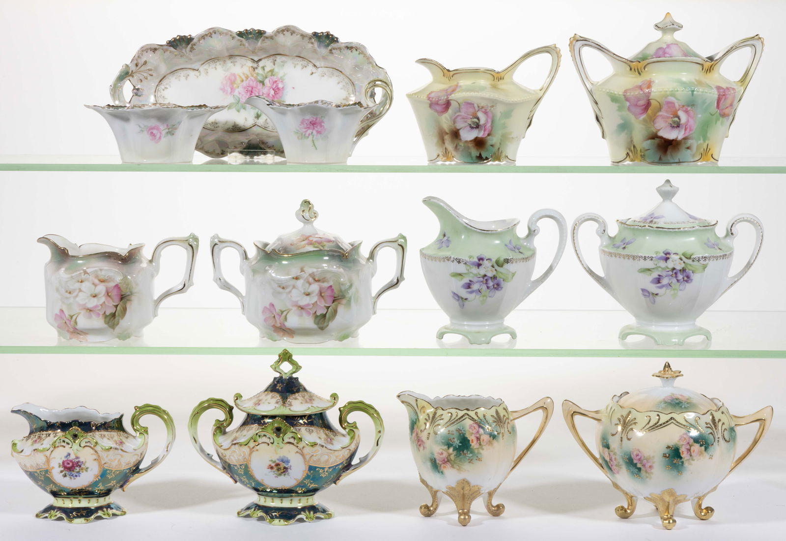 R.S. PRUSSIA PORCELAIN FLORAL MOTIF CREAMER AND SUGAR BOWL SETS, LOT OF SIX: R.S. PRUSSIA PORCELAIN FLORAL MOTIF CREAMER AND SUGAR BOWL SETS, LOT OF SIX, comprising a three-piece set including a creamer, an open sugar, and a 9 1/4" x 4 3/8" open-handled relish