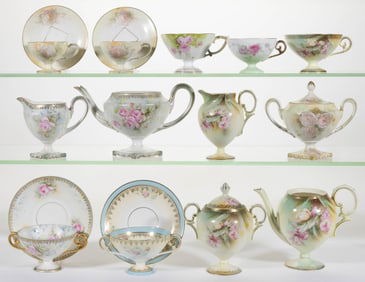 R.S. PRUSSIA PORCELAIN FLORAL MOTIF PEDESTALLED TEA ARTICLES, LOT OF 17